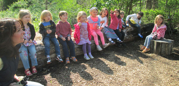 kids learning on a wood log 
