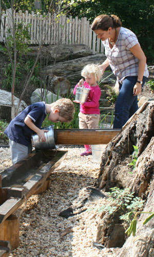  kids playing with the water sluth